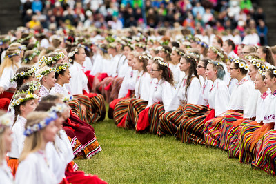Girls are dancing in their traditional estonian costumes