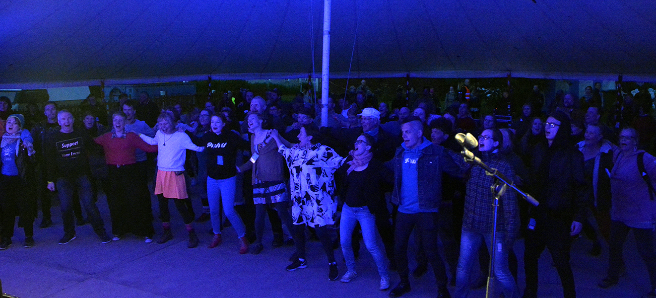 Audience singing in blue light